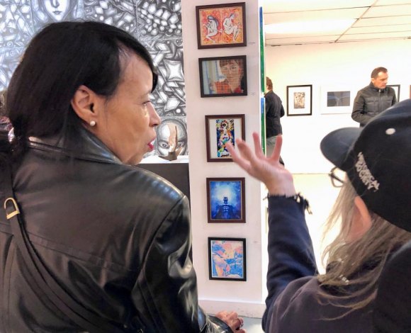 With Vernissage XVIII, RIVAA Returns In Style A visitor listens intently as Anthony Moran explains his latest creations.